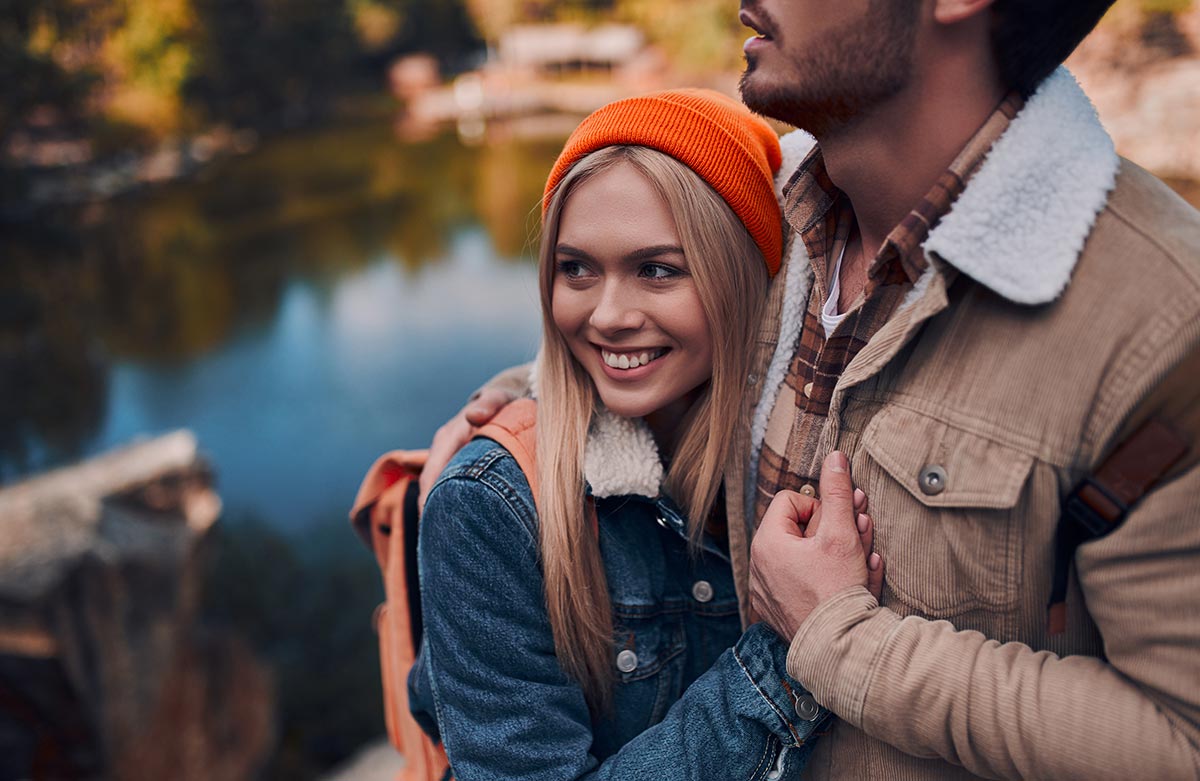 young couple hiking near lake